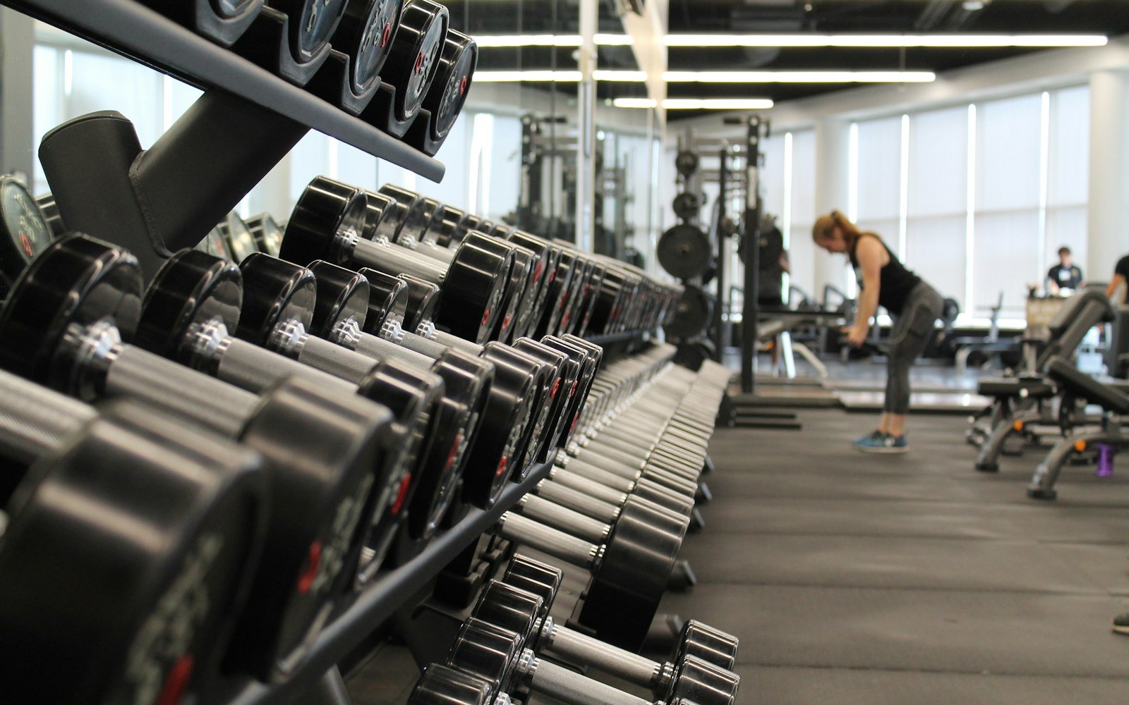 FitnessProTraining personal trainer coaching a client with weights in a Halifax gym